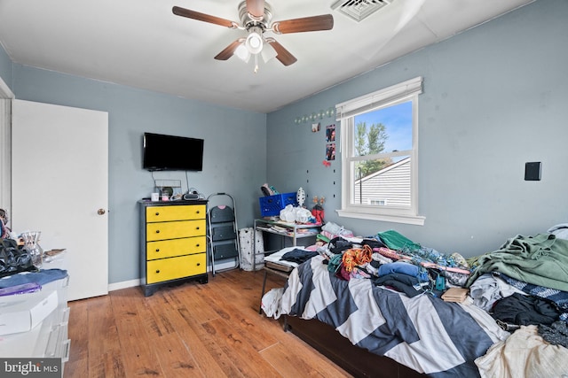 bedroom featuring visible vents, ceiling fan, and hardwood / wood-style floors