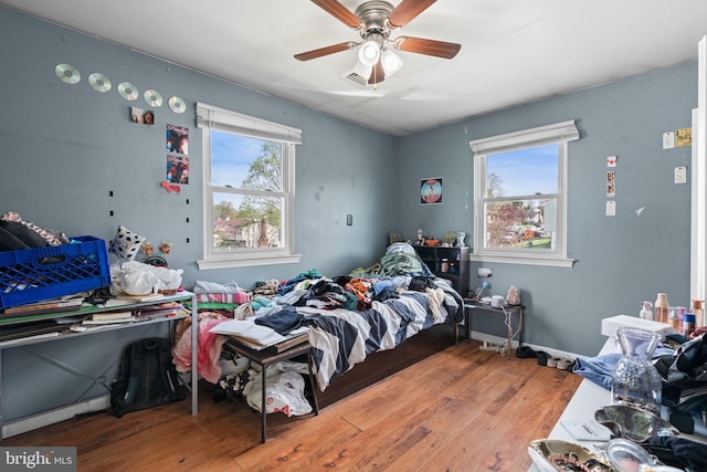 bedroom featuring visible vents, ceiling fan, and wood finished floors