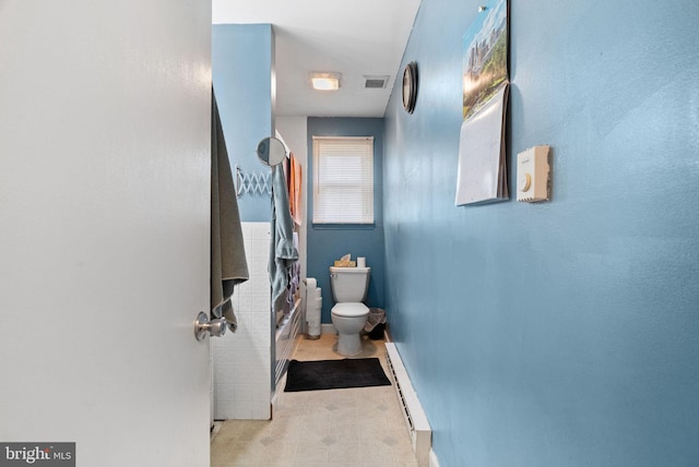bathroom featuring visible vents, tile patterned floors, baseboard heating, and toilet