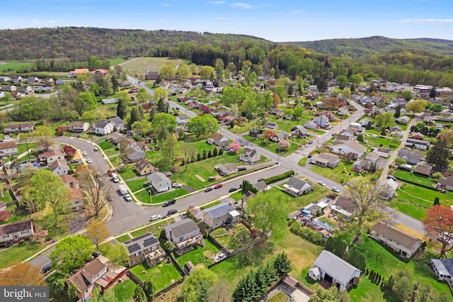 birds eye view of property with a residential view and a wooded view