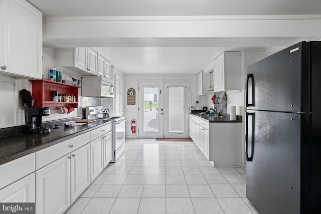 kitchen with french doors, dark countertops, white cabinets, white appliances, and light tile patterned flooring