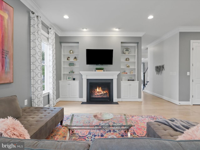 41909 Paddock Gate Pl, Ashburn, VA 20148 - living room with a fireplace with flush hearth, light wood-style floors, built in features, stairs, and crown molding
