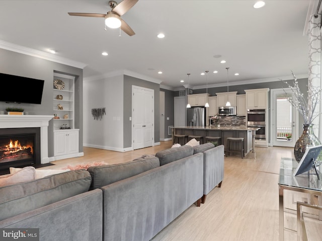 41909 Paddock Gate Pl, Ashburn, VA 20148 - living area featuring recessed lighting, light wood-type flooring, a ceiling fan, ornamental molding, and built in shelves