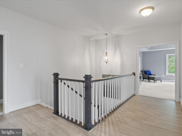 41909 Paddock Gate Pl, Ashburn, VA 20148 - hallway with an upstairs landing, baseboards, and wood finished floors