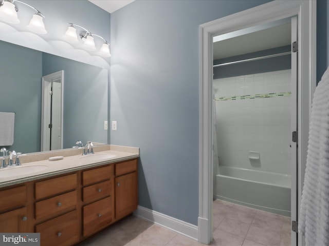 41909 Paddock Gate Pl, Ashburn, VA 20148 - bathroom with double vanity, baseboards, tile patterned floors, and bathing tub / shower combination
