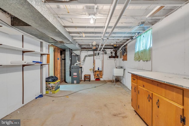unfinished basement featuring tankless water heater, heating unit, and a sink