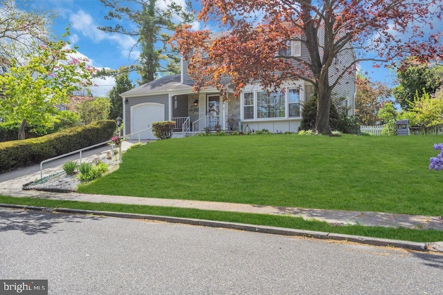 view of front of property with driveway, a front yard, and a garage
