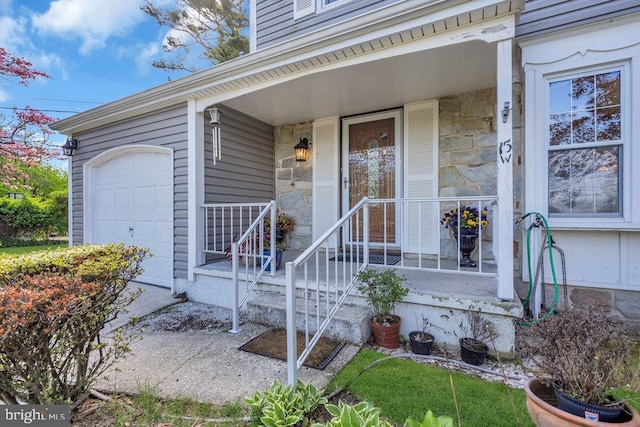 view of exterior entry featuring a porch and stone siding