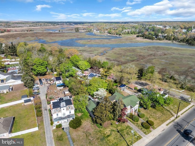 drone / aerial view with a water view and a residential view