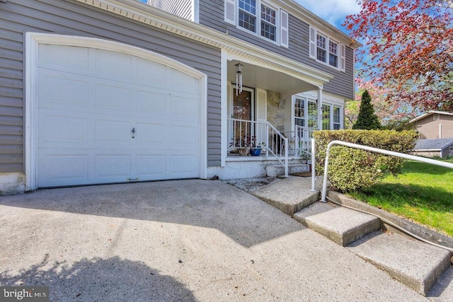 view of front of house featuring a garage, driveway, and stone siding