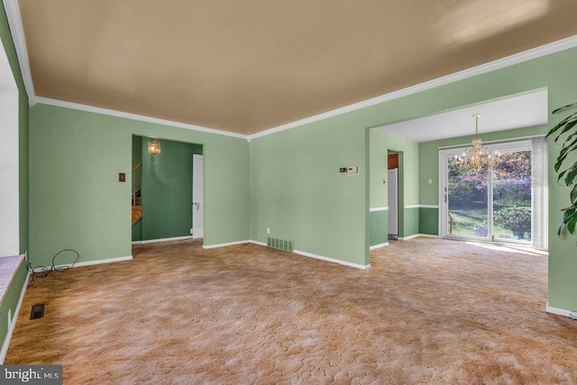spare room with a chandelier, baseboards, visible vents, and ornamental molding