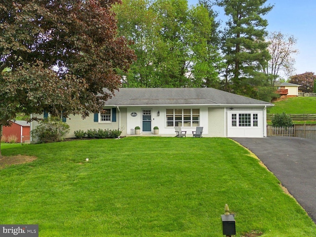 single story home with fence, driveway, and a front yard