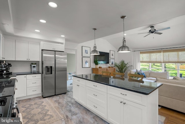 kitchen featuring ceiling fan, electric stove, stainless steel fridge, lofted ceiling, and open floor plan