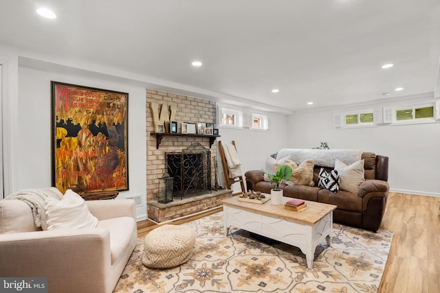 living room with baseboards, a brick fireplace, recessed lighting, and wood finished floors