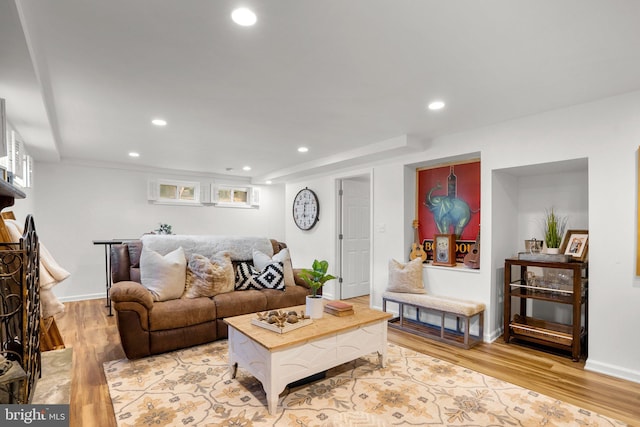 living room with light wood-style floors, baseboards, and recessed lighting