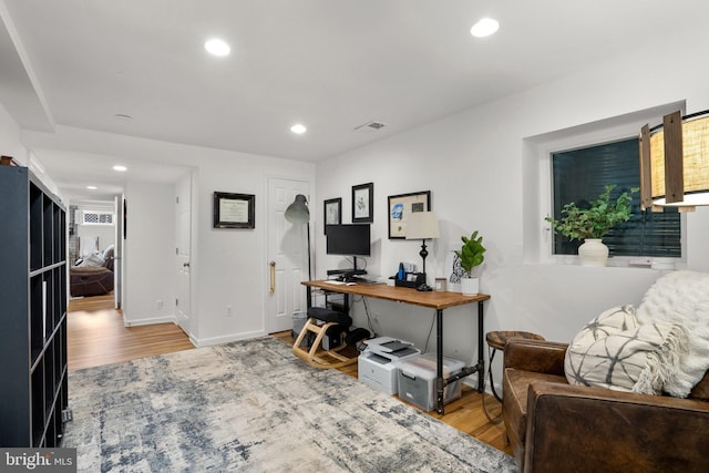 home office with recessed lighting, wood finished floors, and visible vents