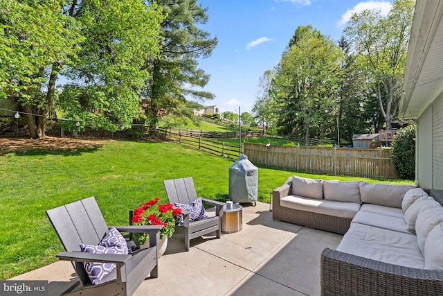 view of patio with an outdoor living space and a fenced backyard