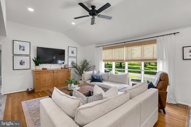 living room featuring a ceiling fan, baseboards, visible vents, and vaulted ceiling