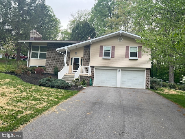 2602 Jeffrey Lori Dr, Finksburg, MD 21048 - split foyer home featuring aphalt driveway, a garage, a chimney, and brick siding