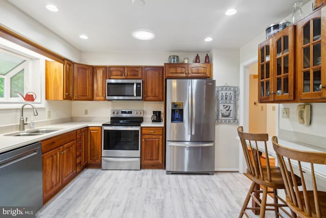 2602 Jeffrey Lori Dr, Finksburg, MD 21048 - kitchen with a sink, stainless steel appliances, light wood finished floors, light countertops, and glass insert cabinets