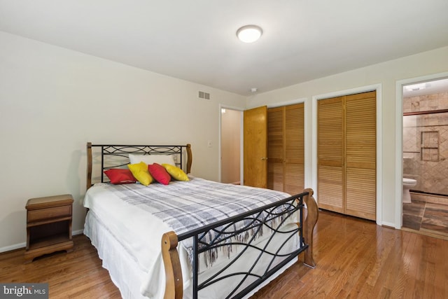2602 Jeffrey Lori Dr, Finksburg, MD 21048 - bedroom featuring baseboards, ensuite bathroom, visible vents, wood finished floors, and multiple closets