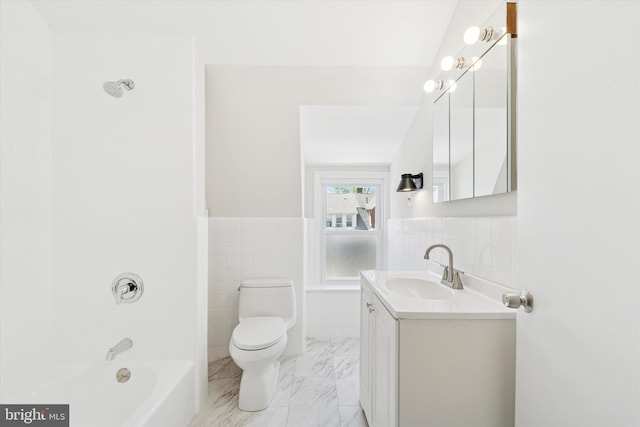 full bathroom with tile walls, a wainscoted wall, vanity, toilet, and marble finish floor
