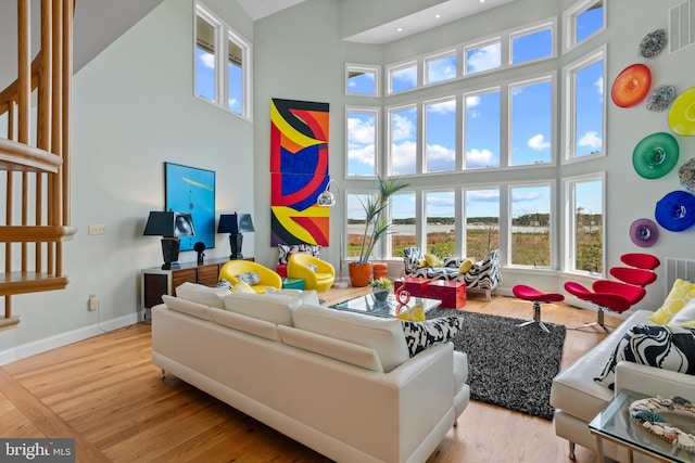 5419 Ragged Point Rd, Cambridge, MD 21613 - living room featuring a towering ceiling, wood finished floors, baseboards, and recessed lighting