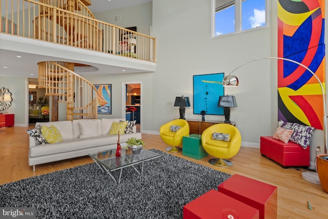 5419 Ragged Point Rd, Cambridge, MD 21613 - living area with stairs, wood finished floors, a towering ceiling, and baseboards