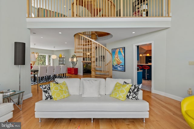 5419 Ragged Point Rd, Cambridge, MD 21613 - living room with stairs, a towering ceiling, wood finished floors, baseboards, and recessed lighting
