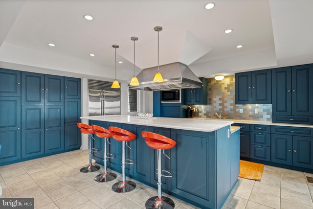 5419 Ragged Point Rd, Cambridge, MD 21613 - kitchen with blue cabinets, light countertops, a kitchen island, light tile patterned floors, and built in microwave