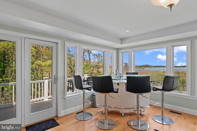 5419 Ragged Point Rd, Cambridge, MD 21613 - sunroom / solarium with plenty of natural light, baseboards, wood finished floors, and a water view