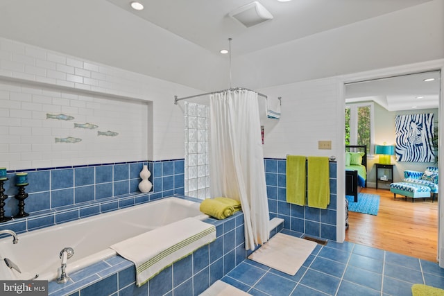 5419 Ragged Point Rd, Cambridge, MD 21613 - bathroom with a relaxing tiled tub, tile patterned flooring, tiled shower, and ensuite bathroom