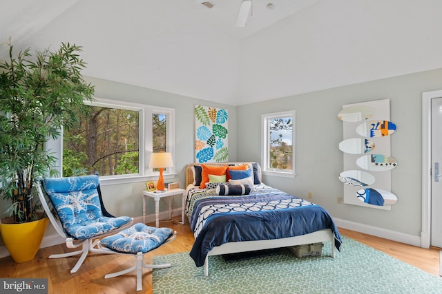 5419 Ragged Point Rd, Cambridge, MD 21613 - bedroom with multiple windows, wood finished floors, lofted ceiling, and baseboards