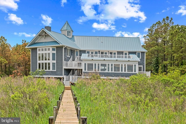 5419 Ragged Point Rd, Cambridge, MD 21613 - back of house with stairway, a standing seam roof, a chimney, metal roof, and a balcony
