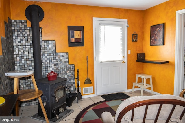 216 Laurel Ct, Pine Grove, PA 17963 - foyer with visible vents, a wood stove, and tile patterned flooring