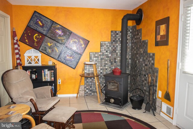 216 Laurel Ct, Pine Grove, PA 17963 - tiled living room with baseboards, a wood stove, and visible vents