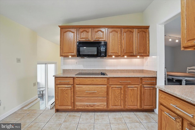 2725 Baublitz Rd, Owings Mills, MD 21117 - kitchen with light tile patterned floors, backsplash, black appliances, and lofted ceiling