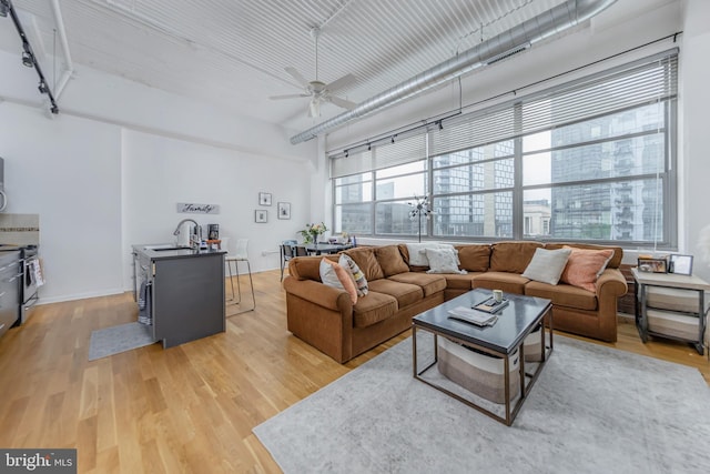 2200 Arch St Unit 514, Philadelphia, PA 19103 - living area featuring light wood finished floors and ceiling fan