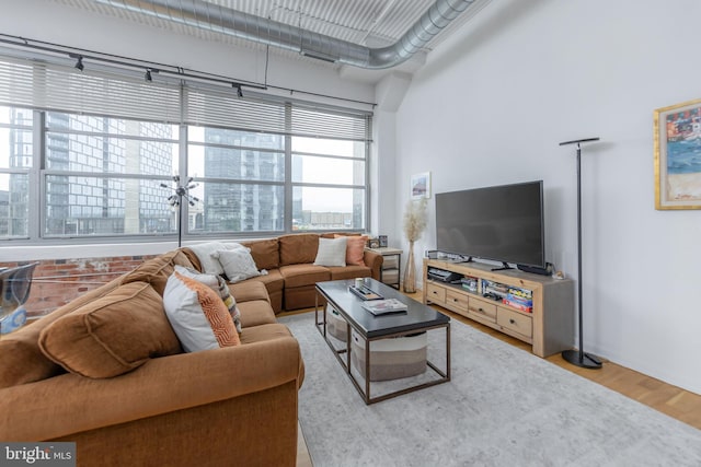 2200 Arch St Unit 514, Philadelphia, PA 19103 - living area featuring visible vents, a towering ceiling, and wood finished floors