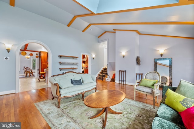 1110 Brantford Ave, Silver Spring, MD 20904 - living room featuring arched walkways, wood-type flooring, stairs, and lofted ceiling