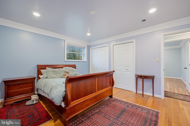 1110 Brantford Ave, Silver Spring, MD 20904 - bedroom featuring baseboards, ornamental molding, two closets, and light wood-style flooring
