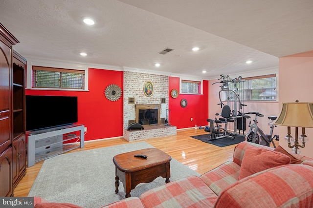 1110 Brantford Ave, Silver Spring, MD 20904 - living area with visible vents, ornamental molding, a fireplace, light wood-style floors, and recessed lighting