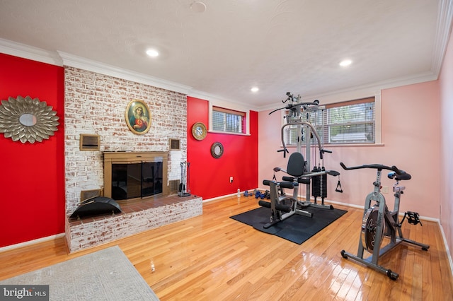 1110 Brantford Ave, Silver Spring, MD 20904 - workout area featuring crown molding, a brick fireplace, and hardwood / wood-style flooring