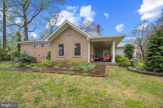 1110 Brantford Ave, Silver Spring, MD 20904 - back of property with brick siding, a lawn, fence, and a chimney