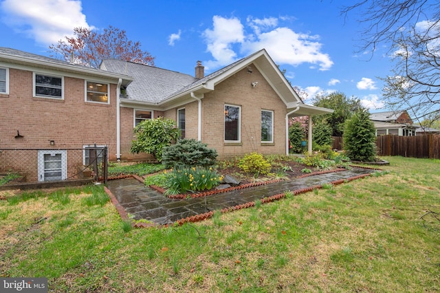 1110 Brantford Ave, Silver Spring, MD 20904 - rear view of property featuring a lawn, brick siding, and fence