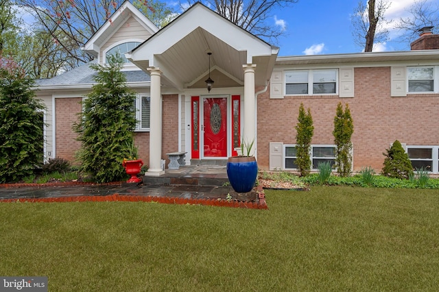 1110 Brantford Ave, Silver Spring, MD 20904 - tri-level home featuring a chimney, a front lawn, and brick siding