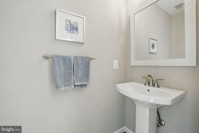 bathroom with baseboards and a sink