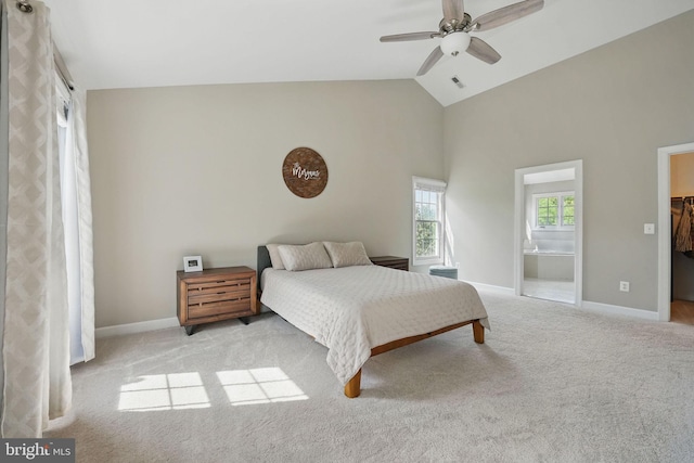 bedroom featuring carpet flooring, high vaulted ceiling, baseboards, and a walk in closet