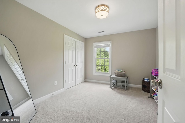 unfurnished bedroom featuring baseboards, carpet, a closet, and visible vents