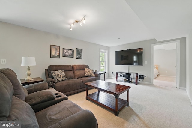 living area featuring light colored carpet and baseboards